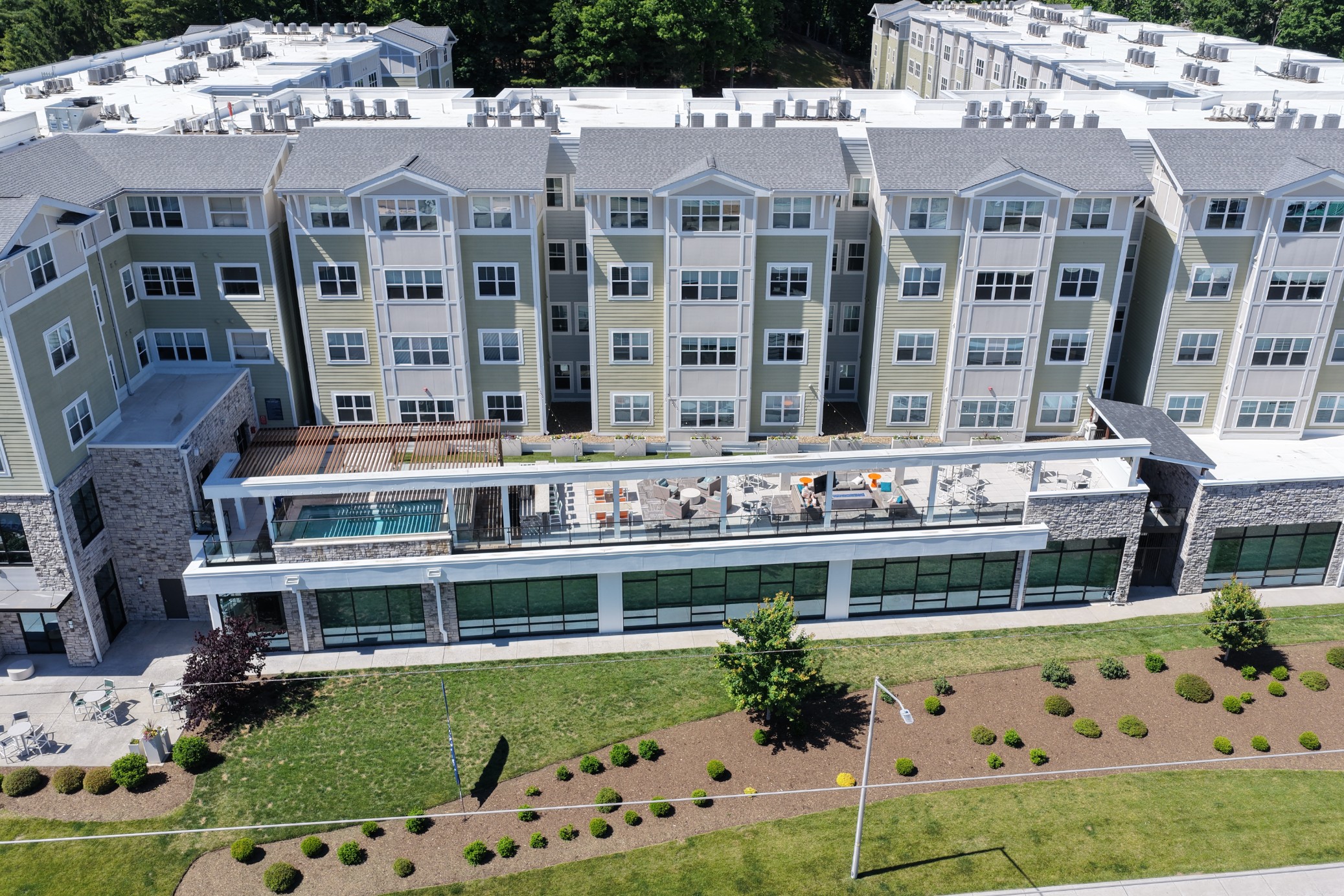 Aerial view of the large outdoor patio with hot tub lounge seating and firepit at The Finmore at 241