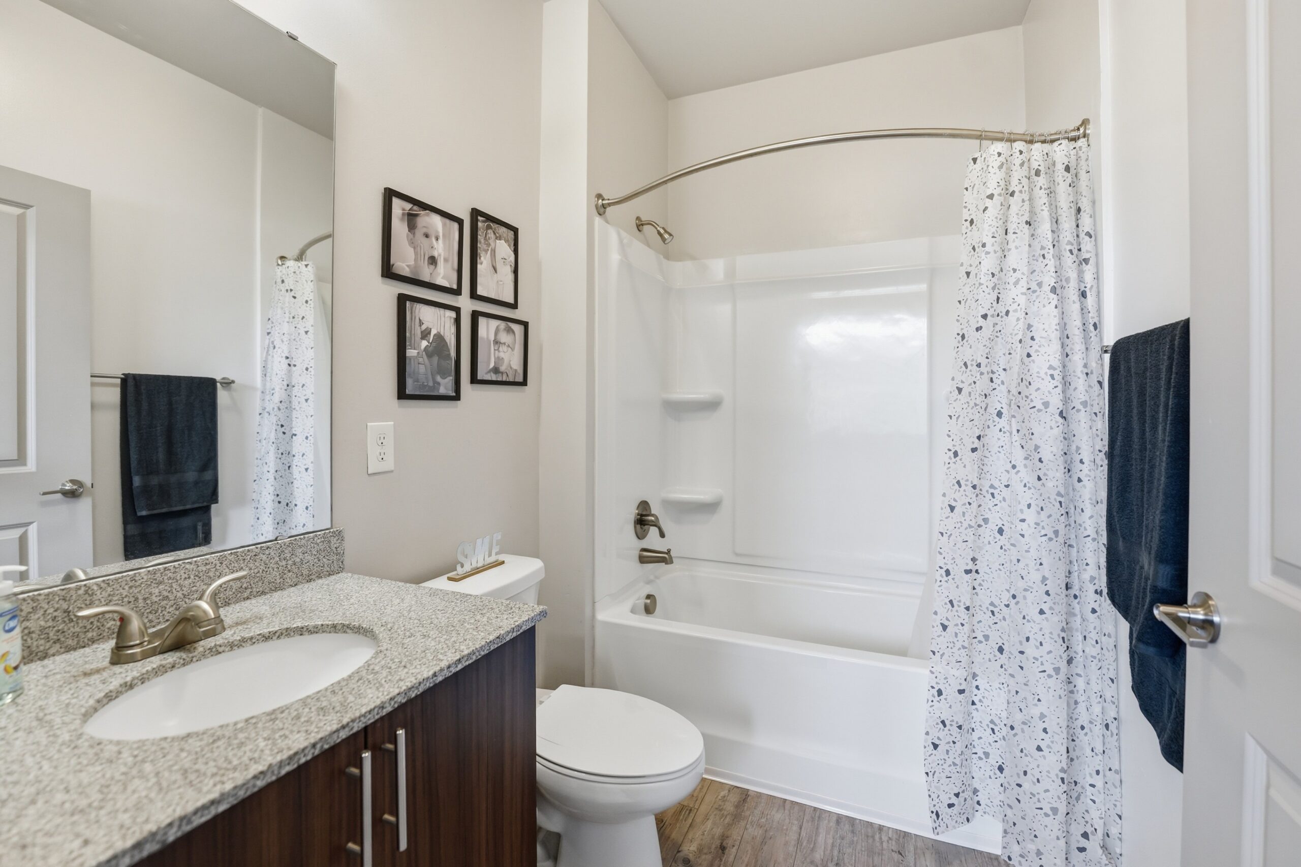 Model bathroom with a tub shower combination at The Finmore at 241 scaled