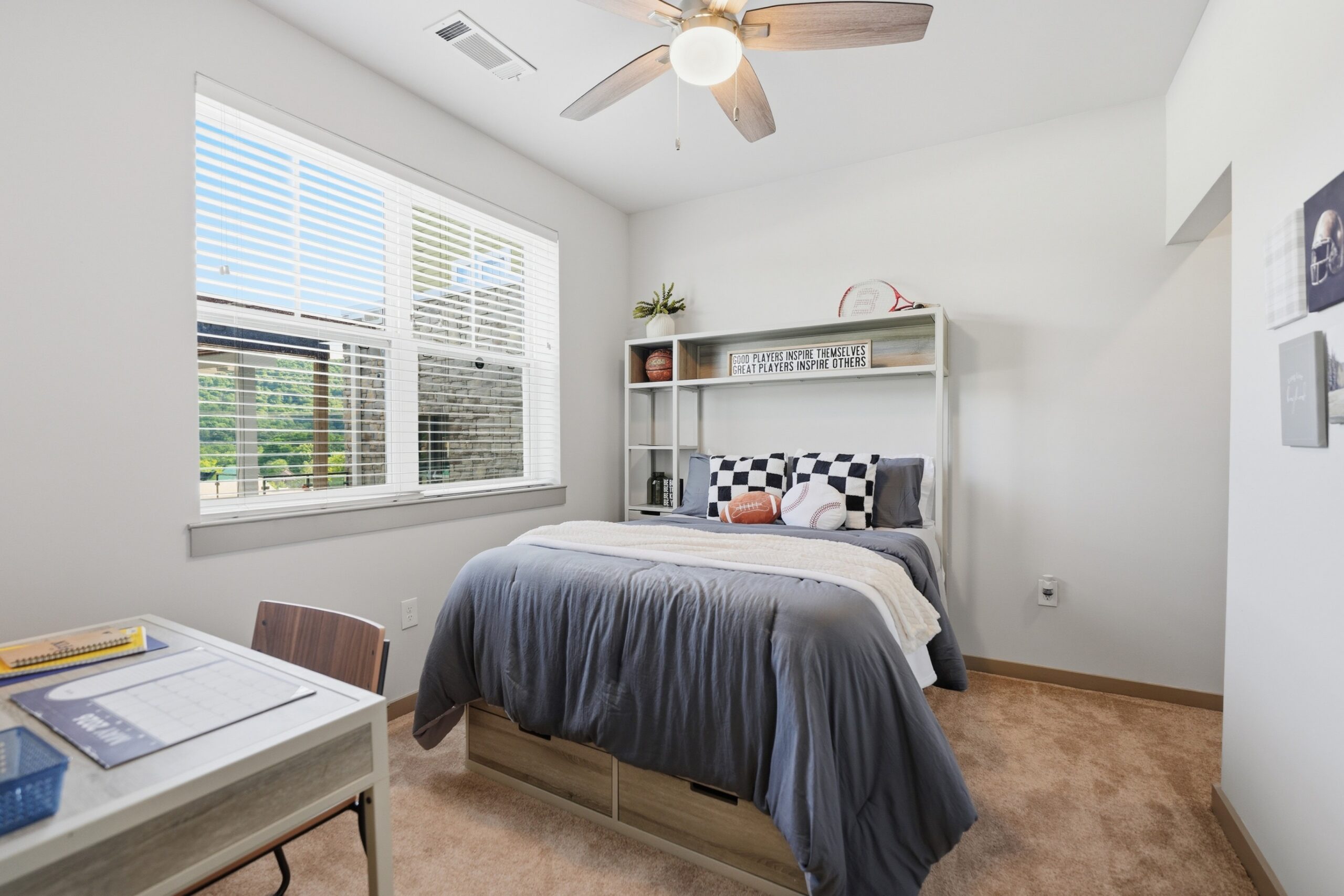 Model bedroom with large window and plush carpeting scaled