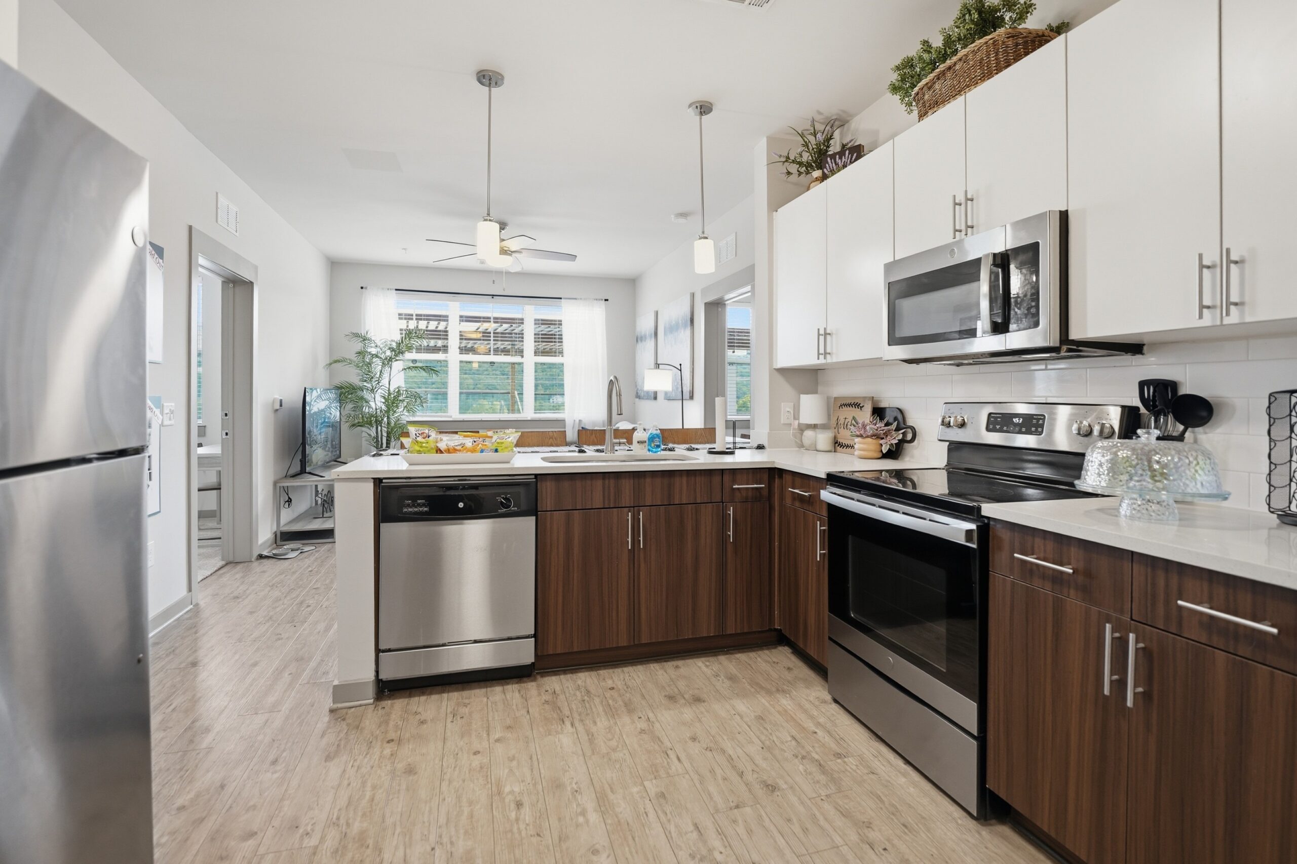 Model kitchen with stainless steel appliances and pendant lighting scaled