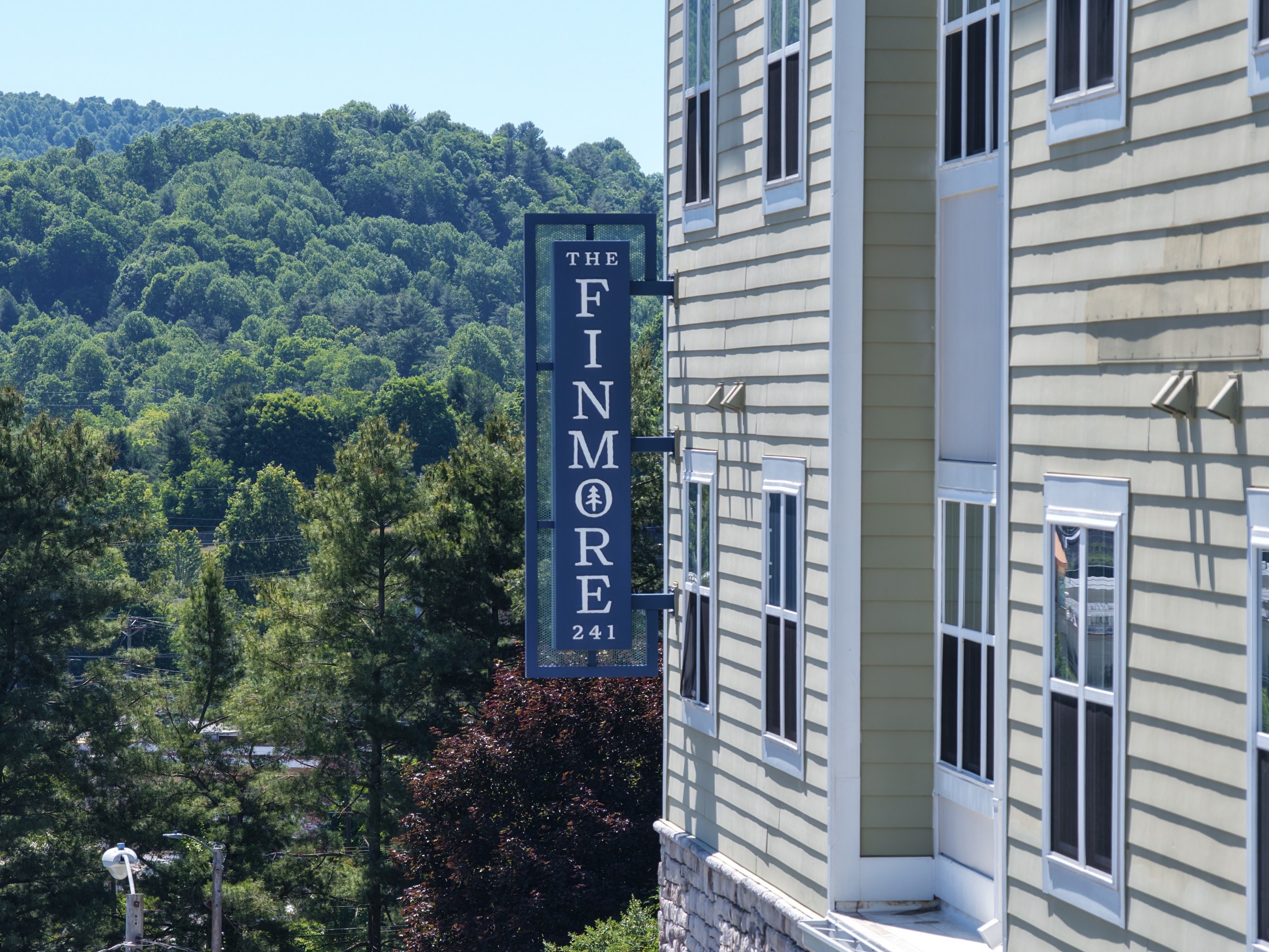 The Finmore at 241 sign on the side of apartment building