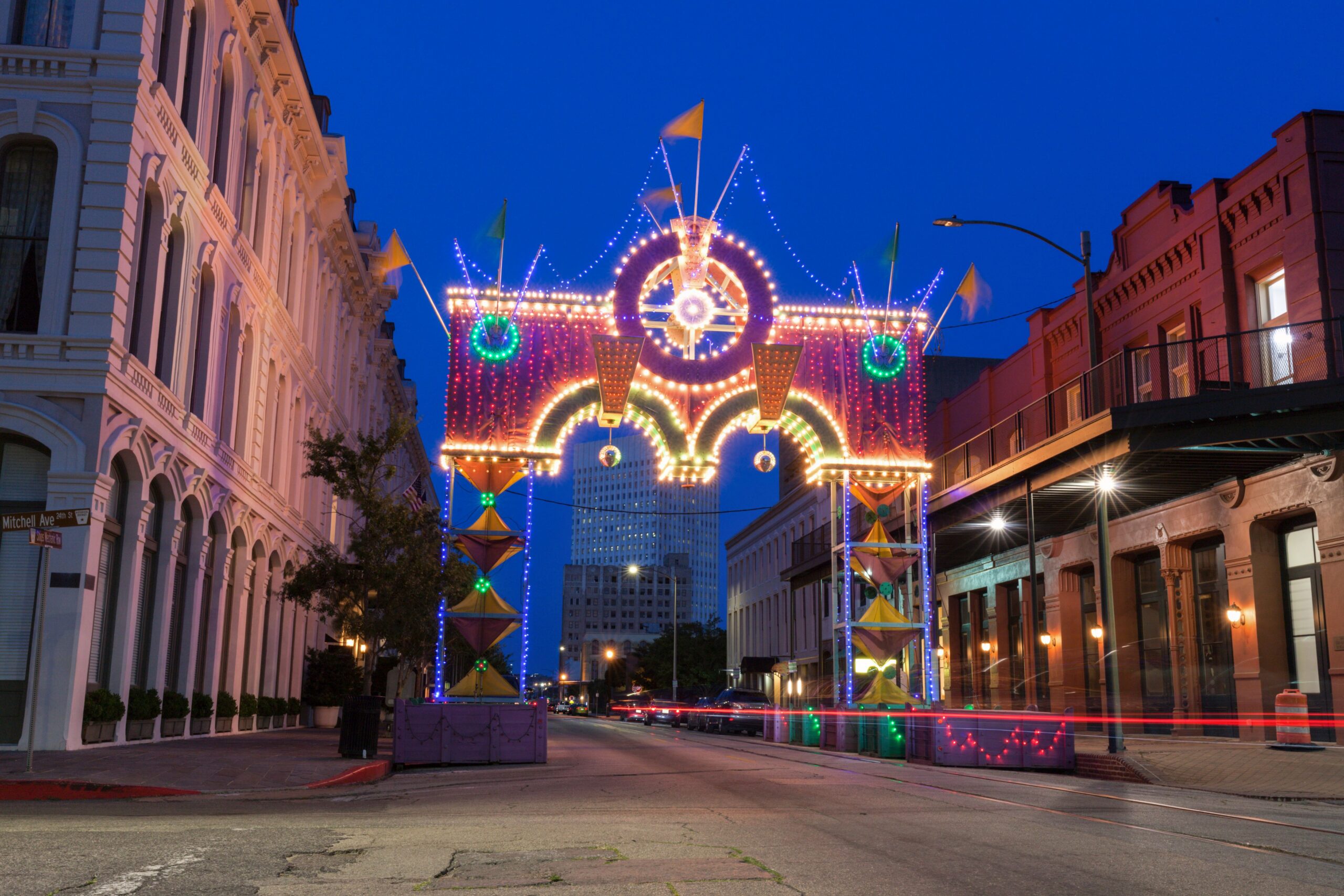 illuminated mardi gras arch over street scaled